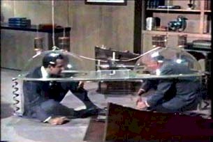 Maxwell Smart (Don Adams) and The Chief (Edward Platt) once again futilely use the Cone of Silence.