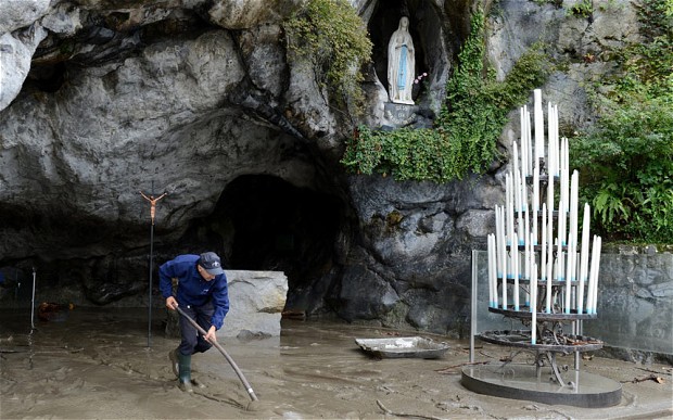 A massive clean-up was under way on Sunday in the French pilgrimage town of Lourdes, famed for its Catholic sanctuaries, after flash floods forced the evacuation of some 450 pilgrims and closed the main shrine. 